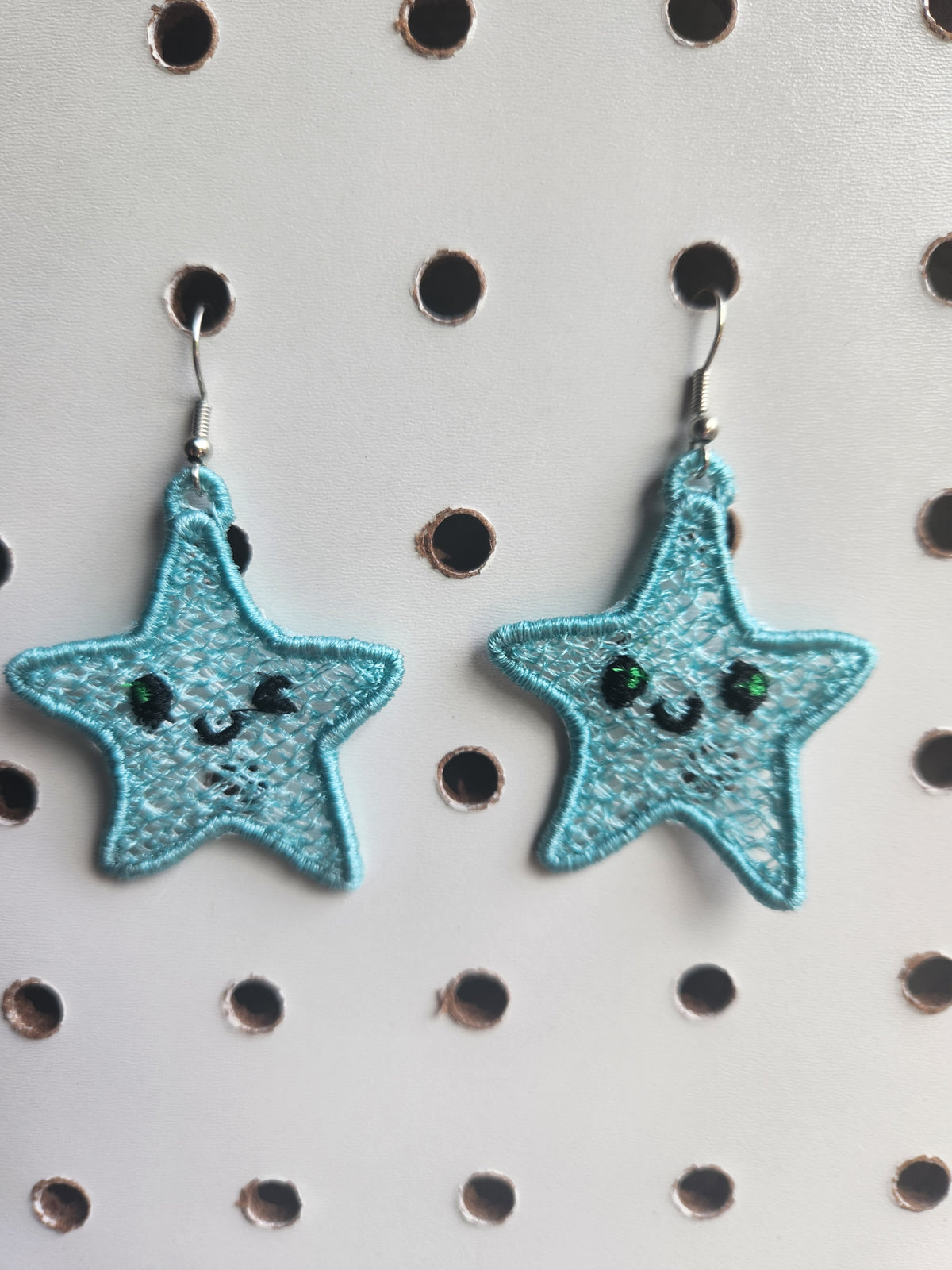 Winking star embroidered earrings
