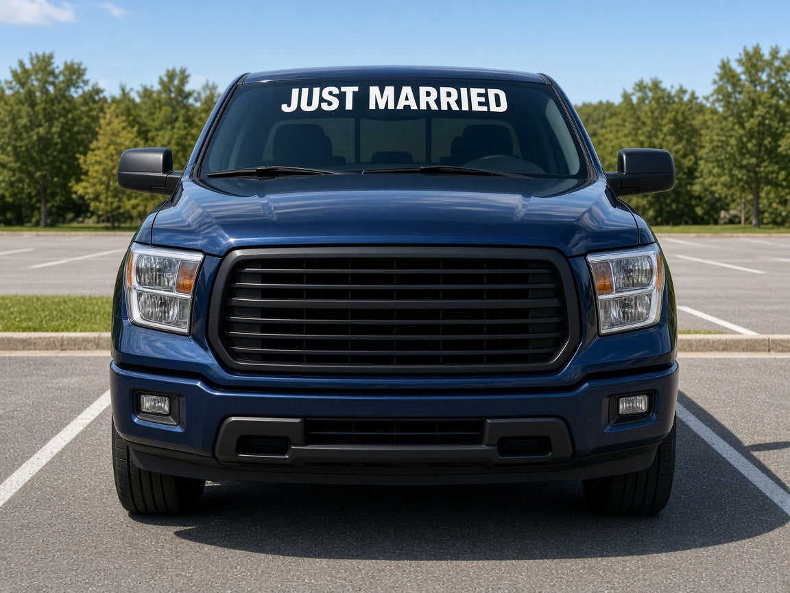 Mockup of white 4 inch JUST MARRIED vinyl lettering across the top of a pickup truck windshield